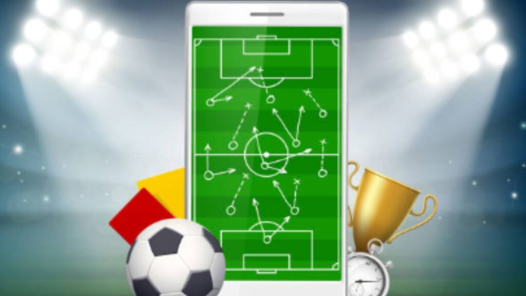 A smartphone displaying a soccer formation, with a ball, whistle, and trophies